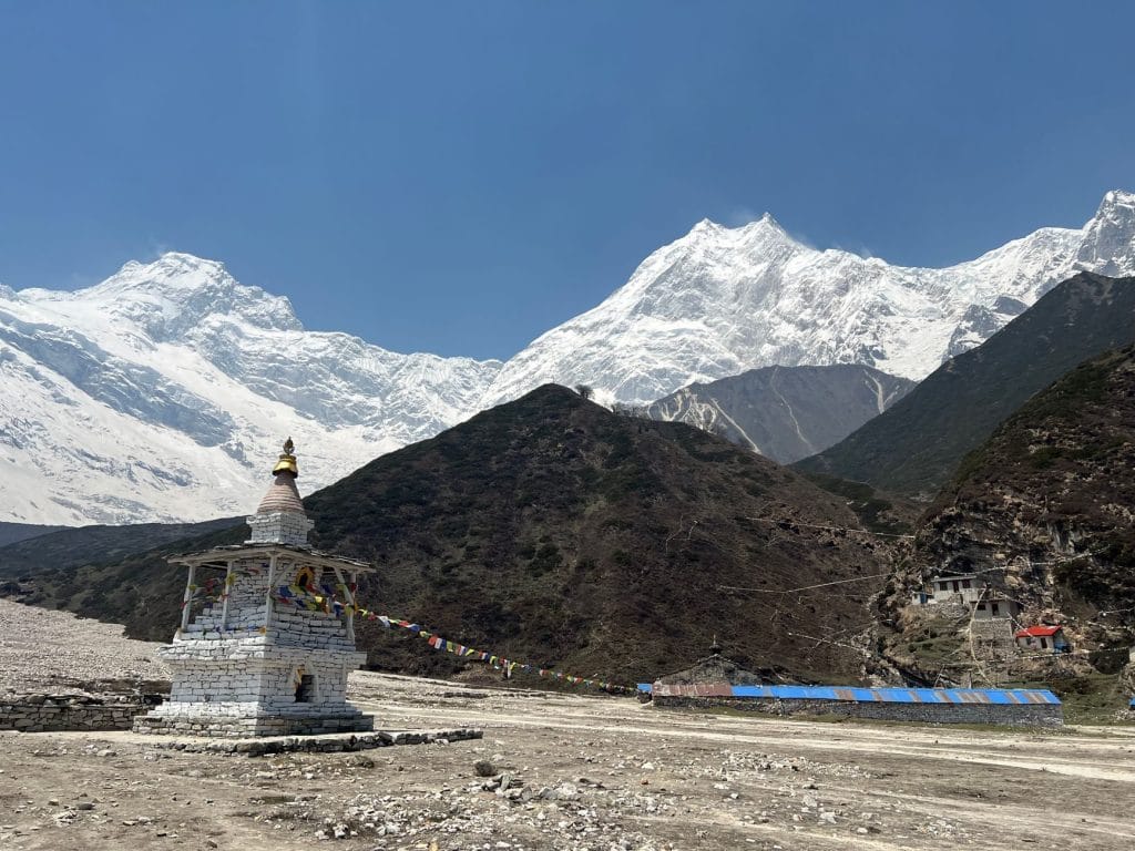 02_Dramatic_view_of_snow_covered_Mount_Manaslu_with_a_traditional_shrine_