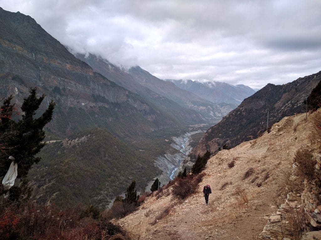 04_A_traveler_hiking_along_a_rugged_trail_in_Nepal_s_mountainous_landscap