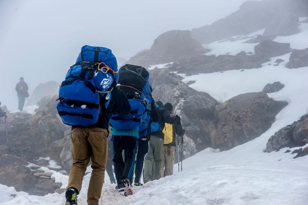 05_A_group_of_hikers_ascending_a_snowy_mountain_trail_in_Ghandruk_Nepal_d