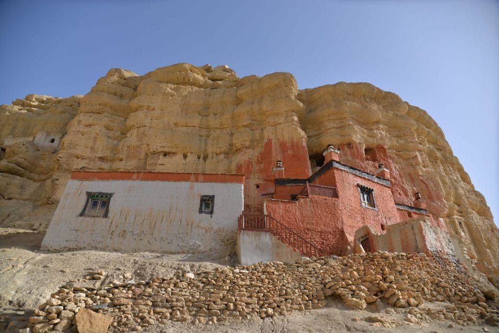 08_Ancient_monastery_built_into_rocky_cliffs_of_Upper_Mustang_Nepal_under