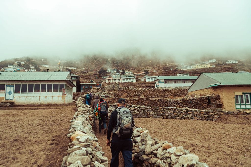 group-of-trekkers-on-a-foggy-day-exploring-a-remote-himalayan-village-.lower-dolpo-treklower-dolpo-trek